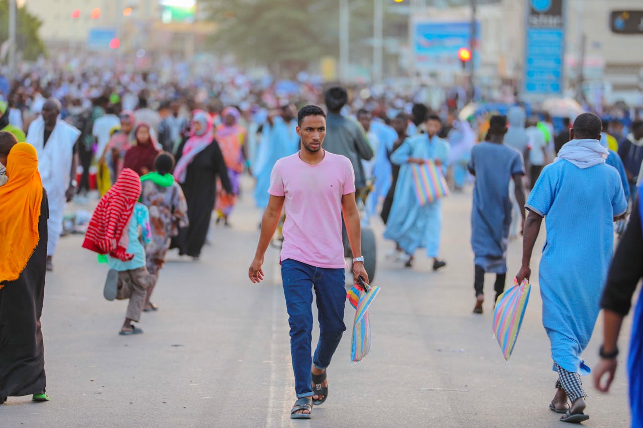 our-services-01 A bustling street scene with people in colorful attire, conveying community and vibrancy.